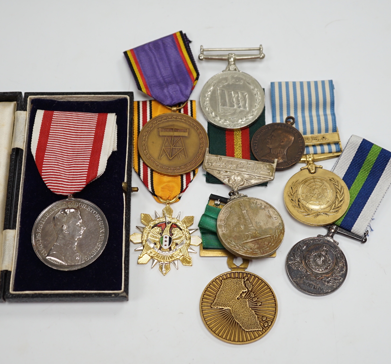 Thirty world military and commemorative medals including; a Belgium War Aid Medal 1914-18, Nigeria Republic Medal, Austri-Hungarian Medal for Bravery, Kuwaiti Liberation Medal, Pakistan Resolution Day Medal, etc.